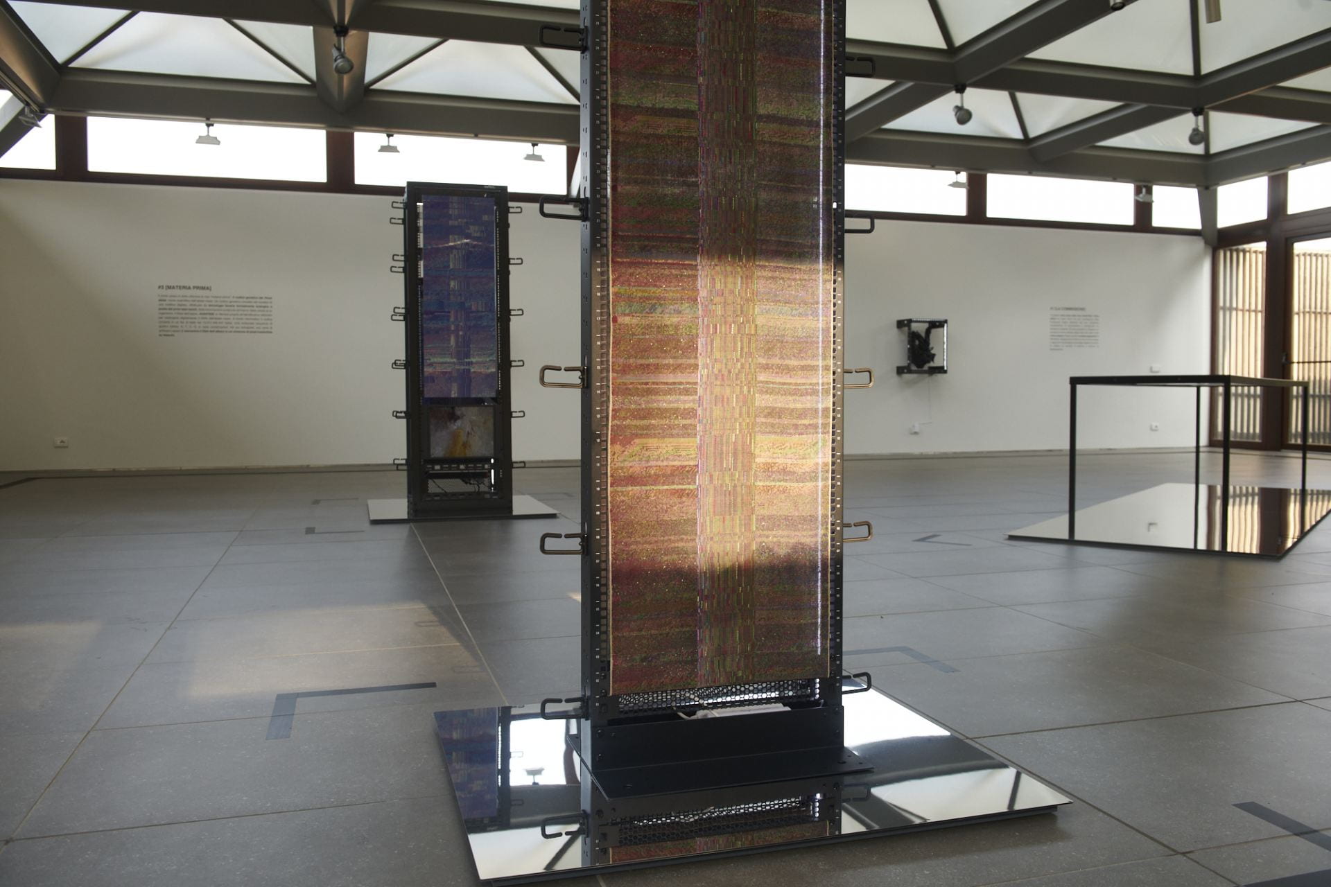 Image shows a sculptural installation with panels of woven material