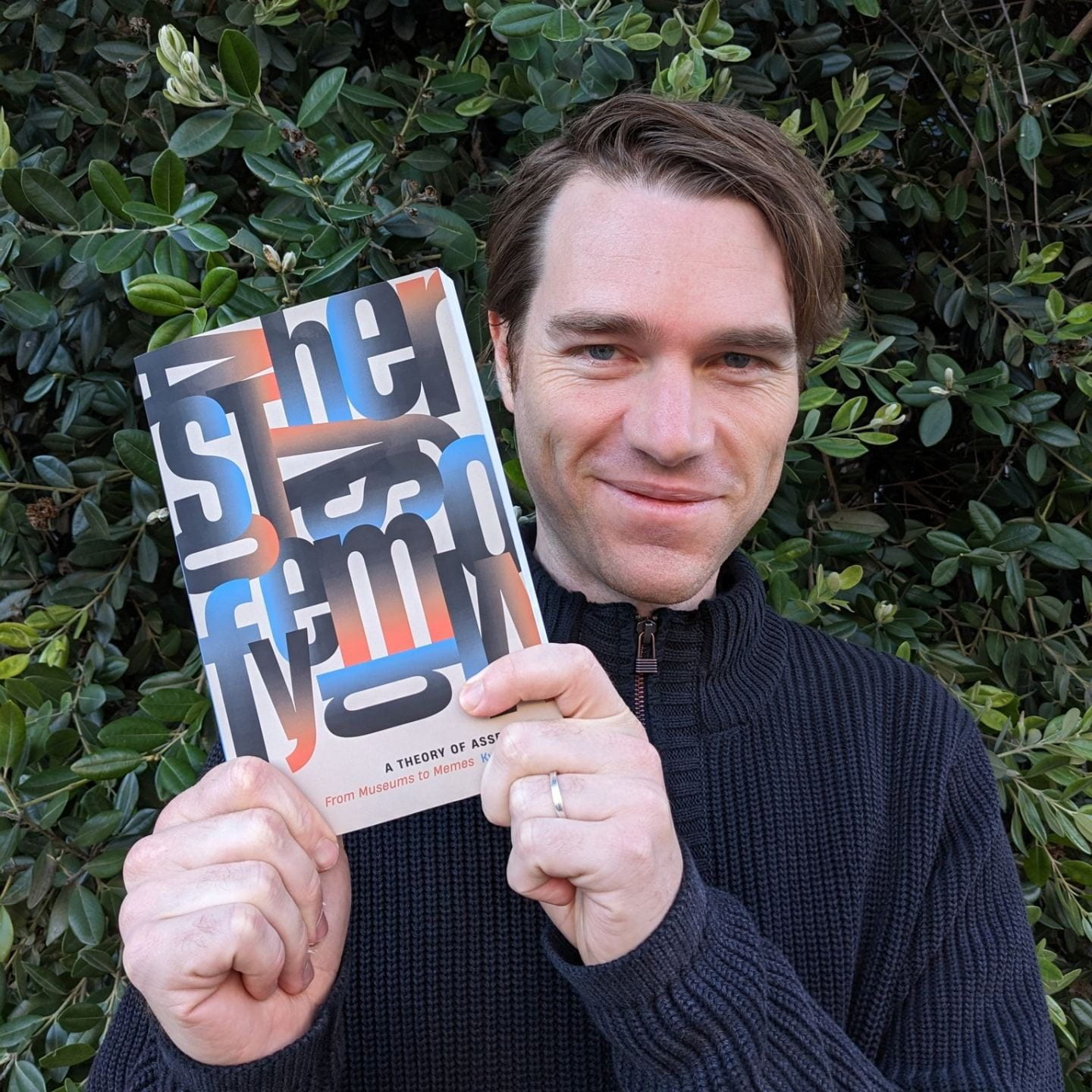 Kyle Parry holding his book A Theory of Assembly
